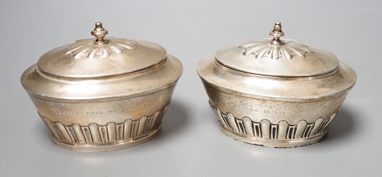 A matched pair of early 20th century silver oval tea caddies, London, 1908 & 191, width 10.5cm and two early 20th century silver leaf caddy spoons, one Britannia standard.